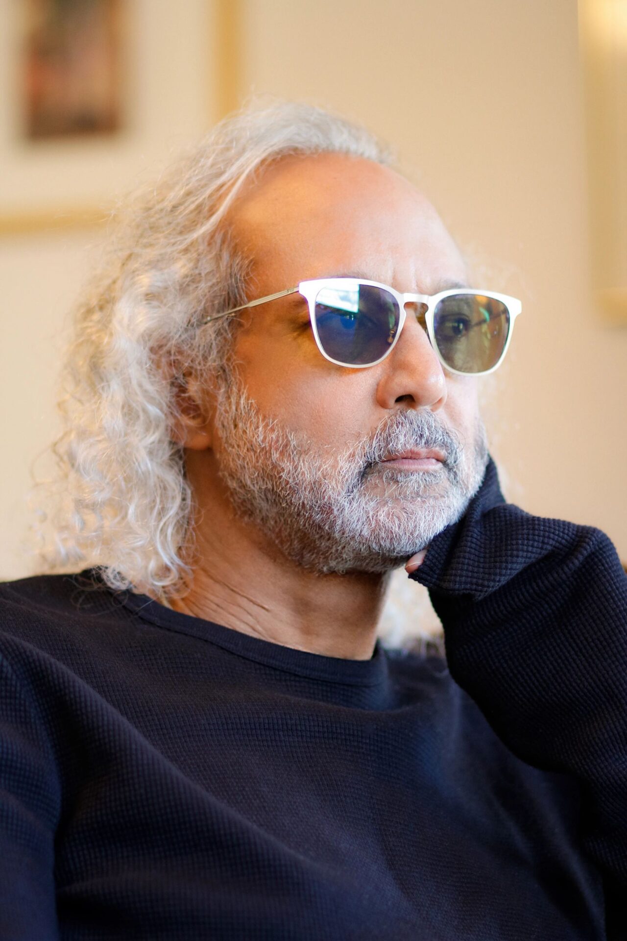 A man with long white hair and sunglasses.